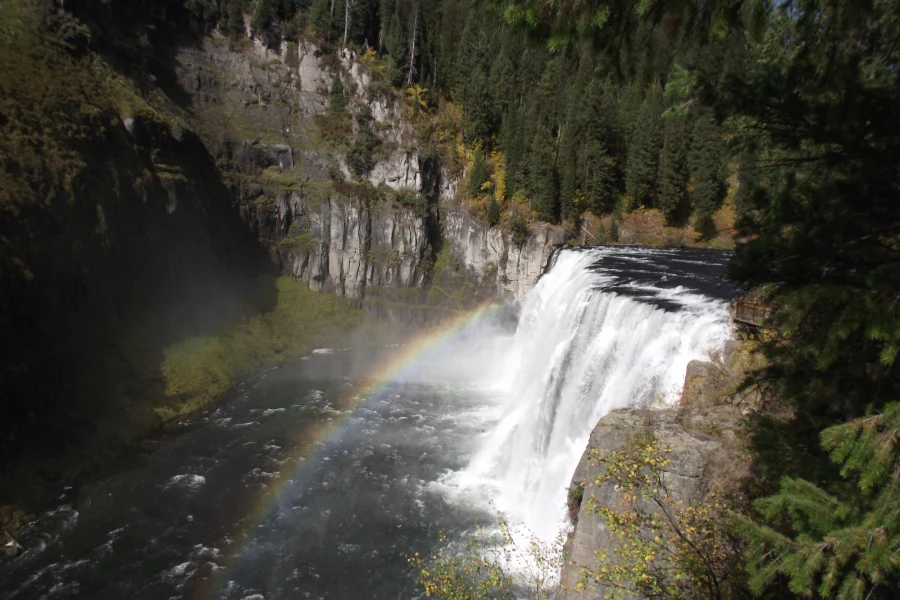 Upper Mesa Falls Fall Upper Mesa Falls with a rainbow in the mist and fall color on the canyon rim