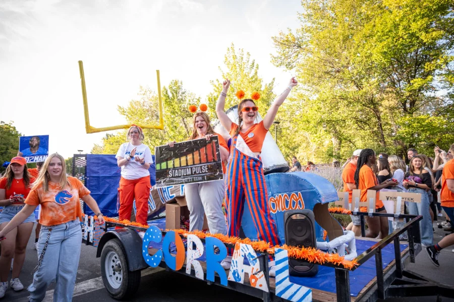 Boise State Homecoming parade float with students cheering Boise State Homecoming parade float with students cheering