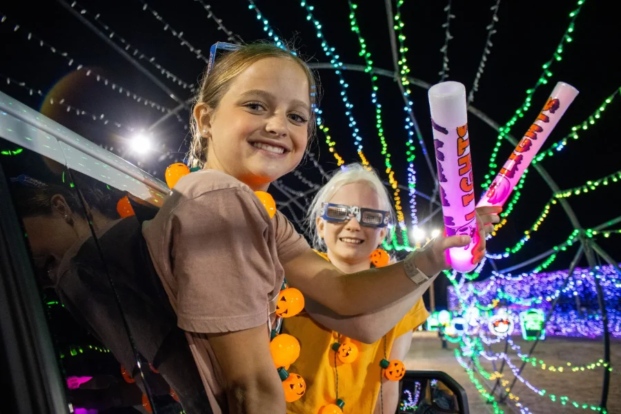 Kids with glow sticks driving through the Spooky Light Show Kids with glow sticks driving through the Spooky Light Show